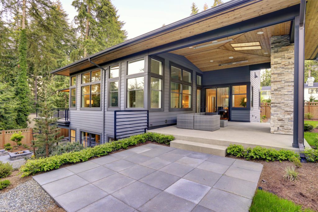 Contemporary home with PVC grey horizontal siding, black window and door trim and black fiberglass asphalt roof.