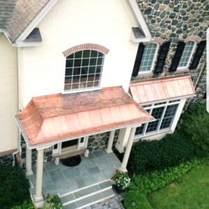 Custom made copper roofs over front entrance and bay window
