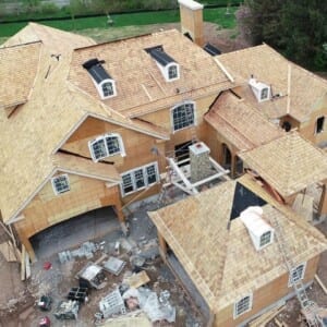 Progress shot of large new construction cedar roof installation