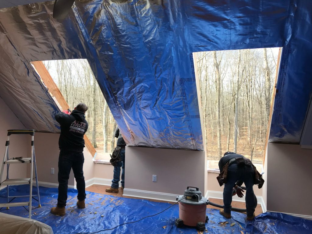Alte Exteriors installers cut holes in the roof in preparation for the Velux Cabrio skylight installation.