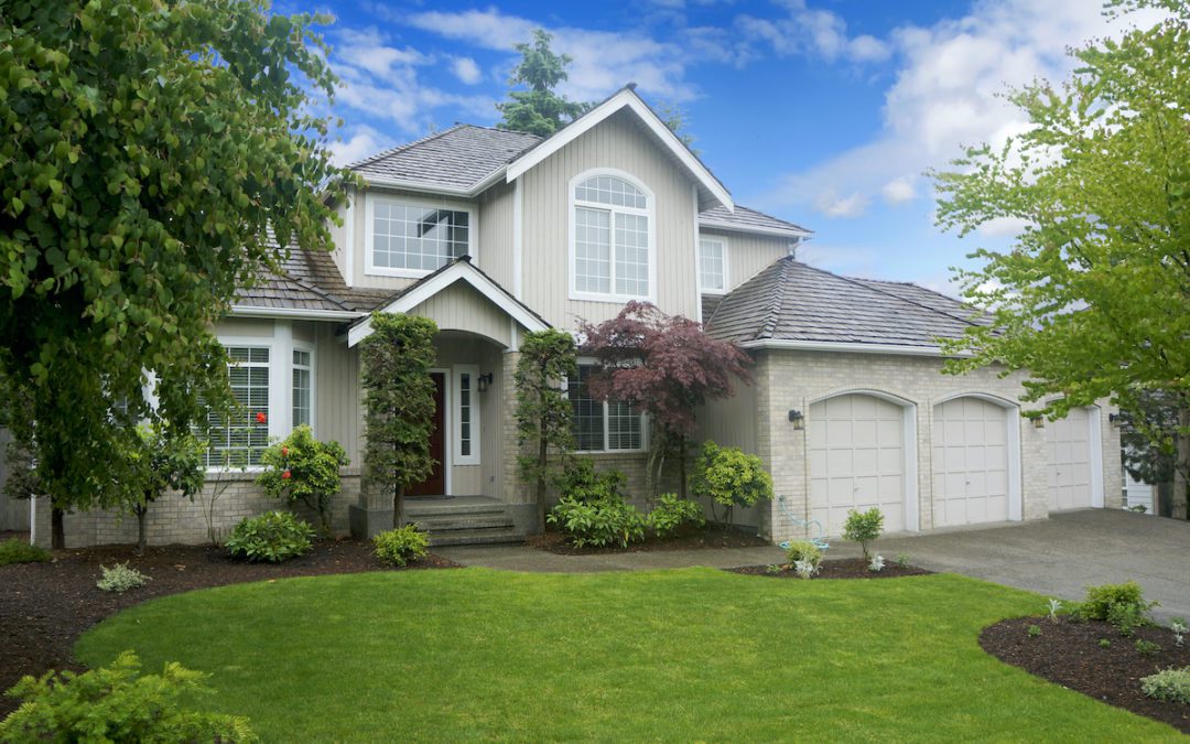 Image of home with new roof and landscaped yard.