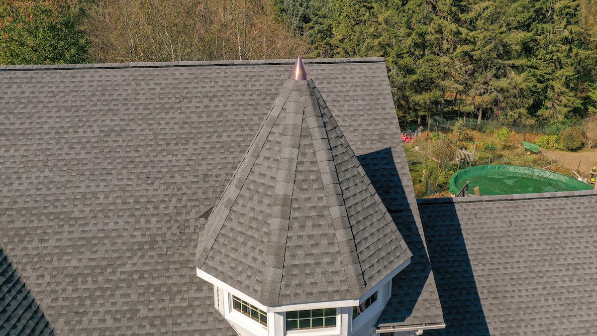 Image of a home in NJ with copper flashing on the turret of a roof.