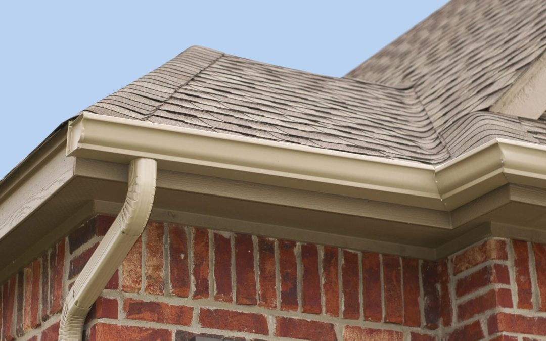 Picture of gutters near the roof of a house.