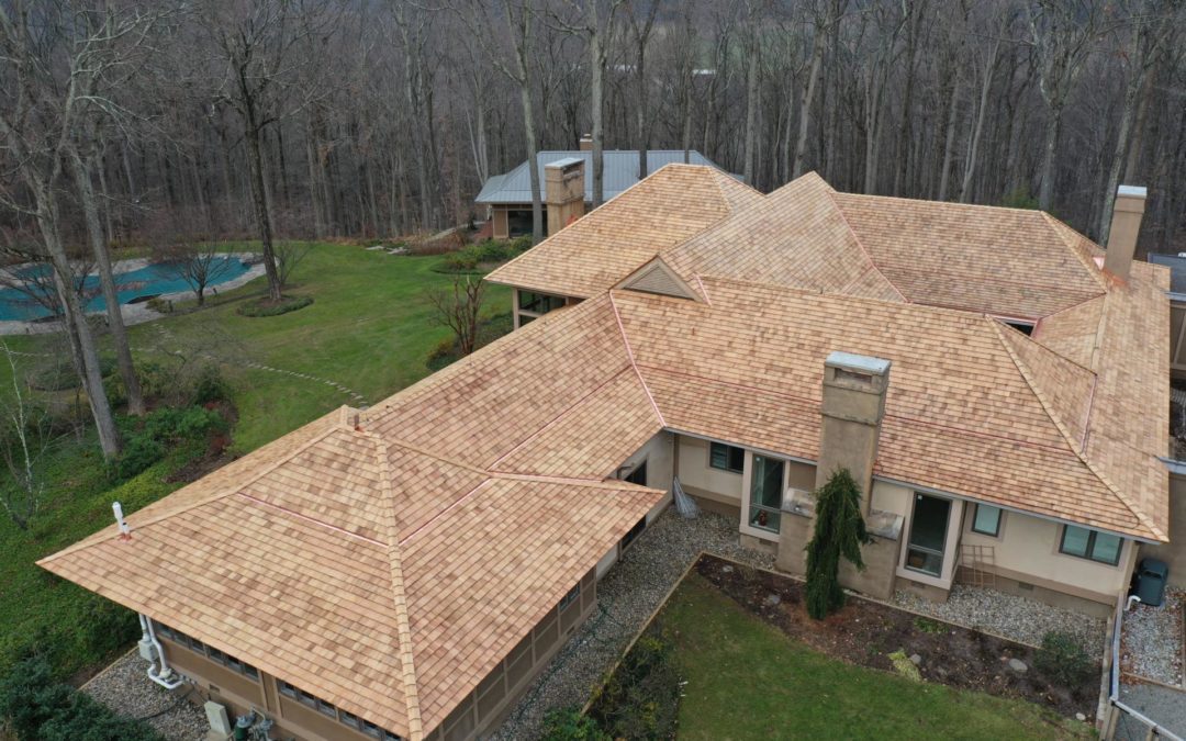 Image of a home with a new cedar shake roof installed by Alte Exteriors