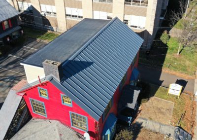 Image of a historic building in Lambertville NJ with standing seam metal roof installed by Alte Exteriors. Bird House Music School Lambertville NJ